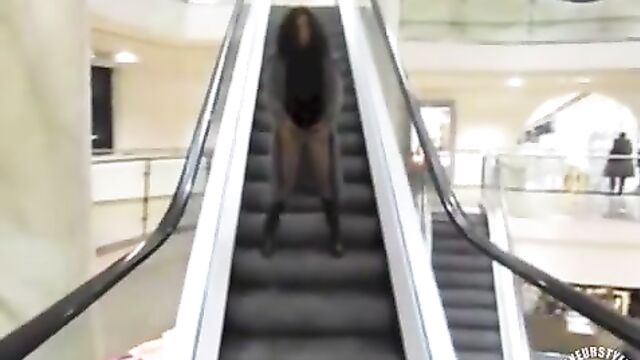 Wife-pissing-on-the-mall-escalator-as-she-rides-it