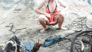Public peeing teen girl on the beach