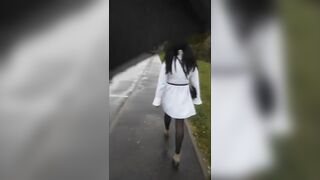 Sissy walks on the street in a new coat