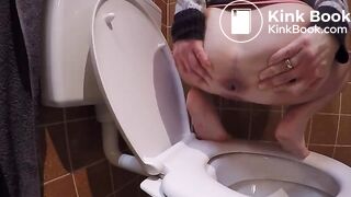 Constipated struggle over toilet