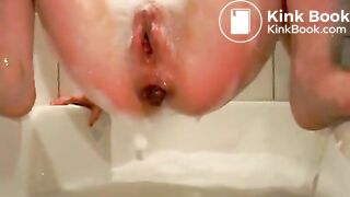 Young girl two floaters in bathtub