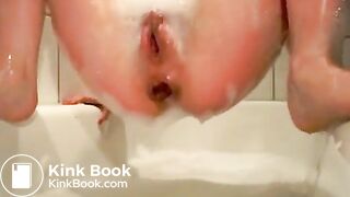 Young girl two floaters in bathtub