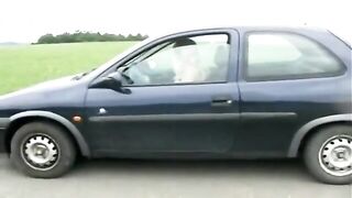 Girl shitting standing near the black car - Pooping and piss