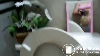 Girl shits over the bowl