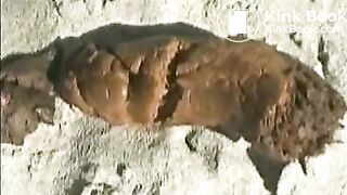 Babe pooping on a sandy beach