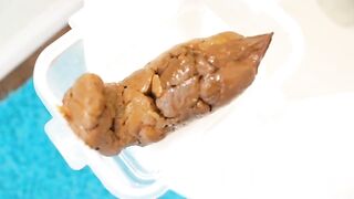 cute girl poops in a plastic food container