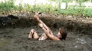 Girl rolling in pig shit pit