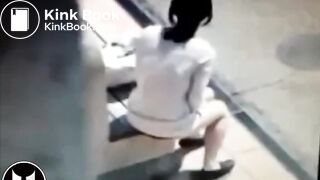 Woman Shitting At Bus Stop