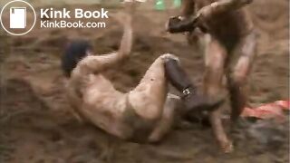 2 girls wrestling on manure field