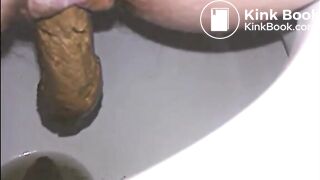 Woman shitting a long turd very slowly in the toilet