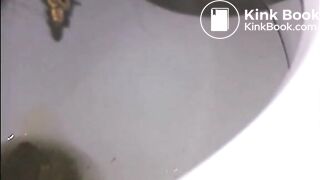 Woman shitting a long turd very slowly in the toilet