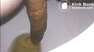 Woman shitting a long turd very slowly in the toilet