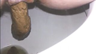 Woman shitting long turd in the toilet