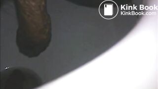 Woman shitting long turd in the toilet