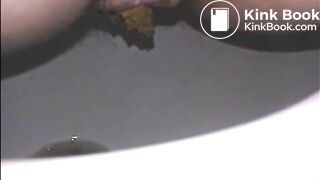 Woman shitting long turd in the toilet