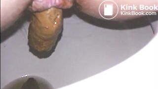 Woman shitting long turd in the toilet