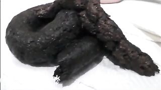 Very sexy brunette in high heels and lingerie shitting a black turd