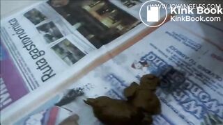 Naomi pooping on newspaper