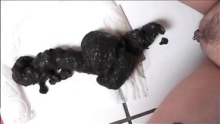 Pierced pussy woman shitting a big quantity of black shit