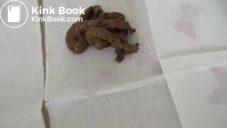 Attractive brunette poops on the floor