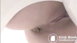 Girl shitting a lot in the toilet closeup