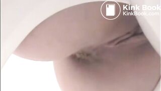 Girl shitting a lot in the toilet closeup
