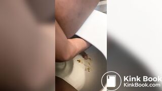 Ebony lady pushing pebbles into the toilet