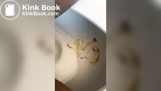 Ebony lady pushing pebbles into the toilet