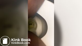Ebony lady pushing pebbles into the toilet
