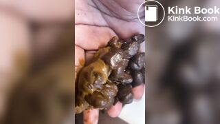 Ebony lady pushing pebbles into the toilet