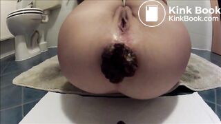 Shaved girl is shitting a very large turd