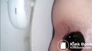 Girl shitting a dark turd in the toilet closeup