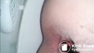 Girl shitting a dark turd in the toilet closeup