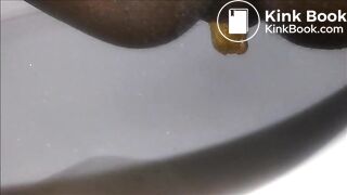 Ebony milf shitting closeup in the toilet