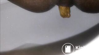 Ebony milf shitting closeup in the toilet