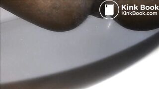 Ebony milf shitting closeup in the toilet