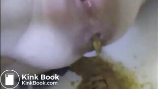 Woman shitting liquid after enema