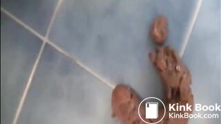Shaved pussy girl shitting a big turd on the bathroom floor