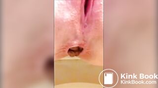 Shaved girl shitting long turd closeup