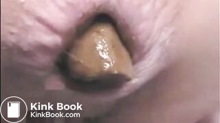 This woman is shitting a huge turd closeup