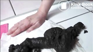 Pierced pussy lips girl shitting a black shit on the floor