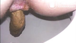 Woman shitting a long turd very slowly in the toilet