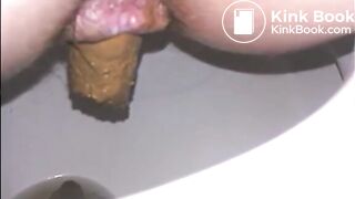 Woman shitting a long turd very slowly in the toilet