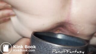 Pissing out of ass in cup