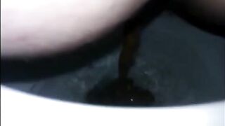 Girl shitting diarrhea in the toilet closeup