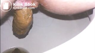 Woman shitting a long turd very slowly in the toilet