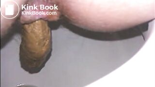 Woman shitting a long turd very slowly in the toilet