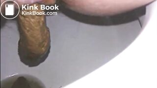 Woman shitting a long turd very slowly in the toilet