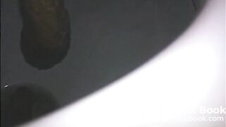 Woman shitting a long turd very slowly in the toilet