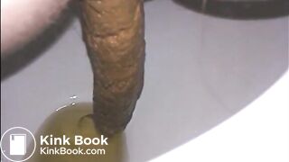 Woman shitting a long turd very slowly in the toilet